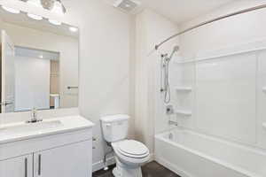 Full bathroom with shower / bathing tub combination, vanity, and toilet