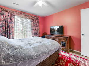 Bedroom featuring ceiling fan and light hardwood / wood-style flooring