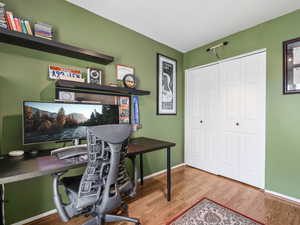 Home office with hardwood / wood-style floors