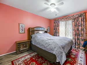 Bedroom featuring hardwood / wood-style floors and ceiling fan