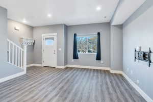 Entrance foyer with light wood-type flooring