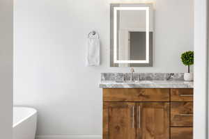 Bathroom featuring a bathtub and vanity