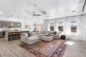 Living room featuring ceiling fan, light hardwood / wood-style flooring, and sink