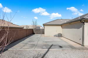 Rear view of house with central AC unit and a patio