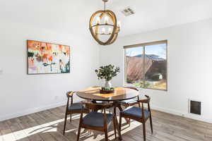 Dining space featuring a mountain view, an inviting chandelier, and wood-type flooring