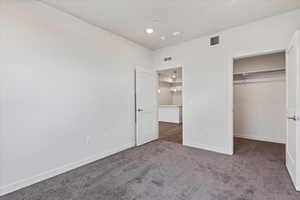 Unfurnished bedroom with a closet and carpet flooring