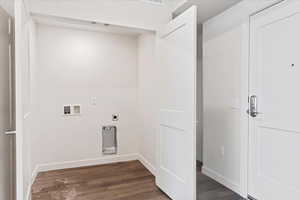 Washroom featuring electric dryer hookup, hookup for a washing machine, and dark hardwood / wood-style floors