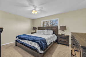 Bedroom featuring ceiling fan and light carpet