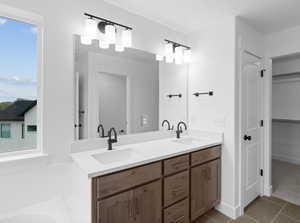 Bathroom featuring tile patterned flooring, a sink, and double vanity