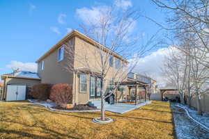 Rear view of house featuring a gazebo, a patio, and a yard