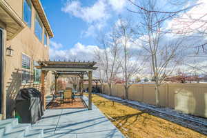 View of patio with a pergola and a grill