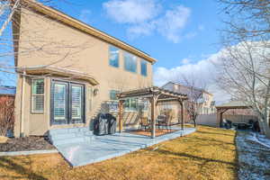 Rear view of property featuring a gazebo, a patio area, a lawn, and a pergola