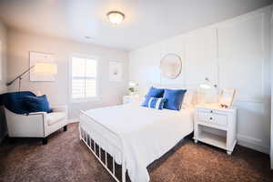 Bedroom with dark colored carpet