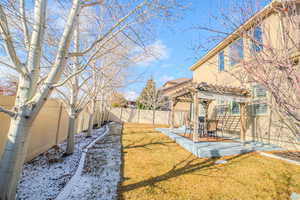 View of yard featuring a patio area and a pergola