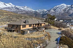 Back of property with a deck with mountain view