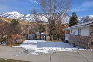 Exterior space featuring a mountain view and a storage shed