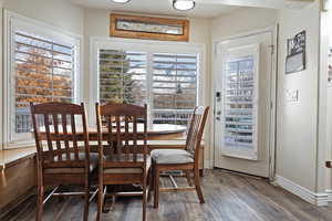 Dining space with hardwood / wood-style flooring