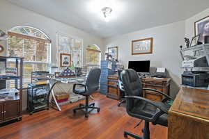 Office area with plenty of natural light and hardwood / wood-style flooring