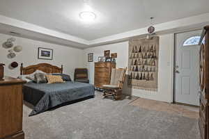 Bedroom featuring light carpet