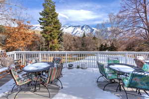 Snow covered deck with a mountain view