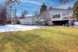 Rear view of house featuring a yard