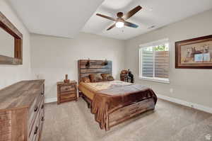 Carpeted bedroom with ceiling fan