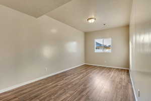 Fourth bedroom featuring dark hardwood / wood-style floors