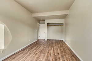 Unfurnished bedroom featuring a closet and hardwood / wood-style floors