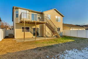 Rear view of house with a patio area and central AC unit