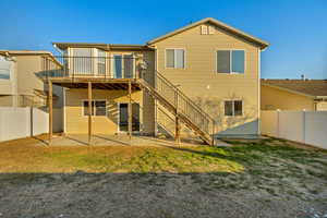 Rear view of property with a patio area and a lawn