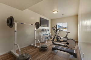 Virtually staged Workout area with hardwood / wood-style flooring