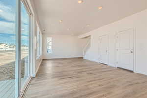 Empty room with light hardwood / wood-style floors