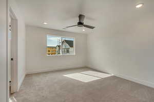 Unfurnished room with recessed lighting, light colored carpet, baseboards, and ceiling fan