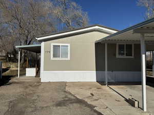 View of side of property with a carport