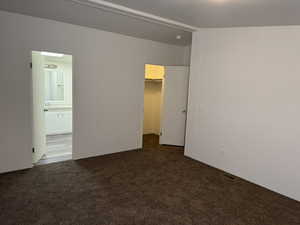 Carpeted empty room featuring sink