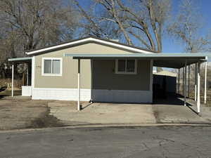 View of front facade with a carport