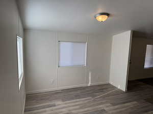 Spare room with dark wood-type flooring