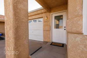 View of exterior entry with a garage