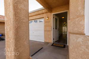 View of exterior entry with a garage