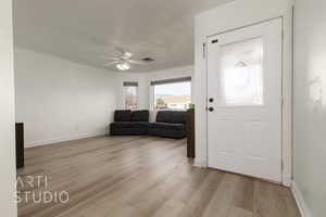 Foyer with ceiling fan and light hardwood / wood-style floors