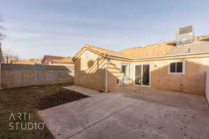 Back of house with central air condition unit and a patio