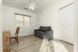 Office with ceiling fan and light hardwood / wood-style floors