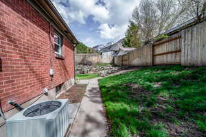 View of yard with central air condition unit and a mountain view