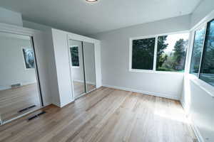 Unfurnished bedroom with light hardwood / wood-style floors