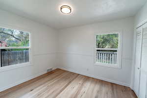 Unfurnished bedroom with a closet and light hardwood / wood-style flooring