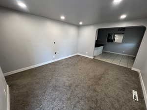 Unfurnished living room with light carpet