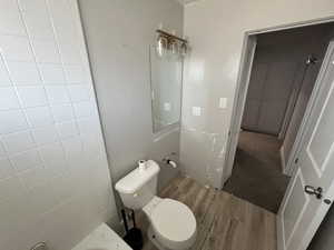 Bathroom with toilet and hardwood / wood-style floors