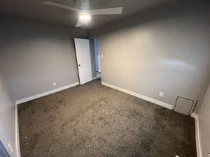 Spare room featuring ceiling fan and carpet floors