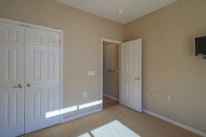 2nd Bedroom featuring a closet and light carpet