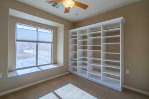 2nd bedroom with window seat, extra shelving and ceiling fan